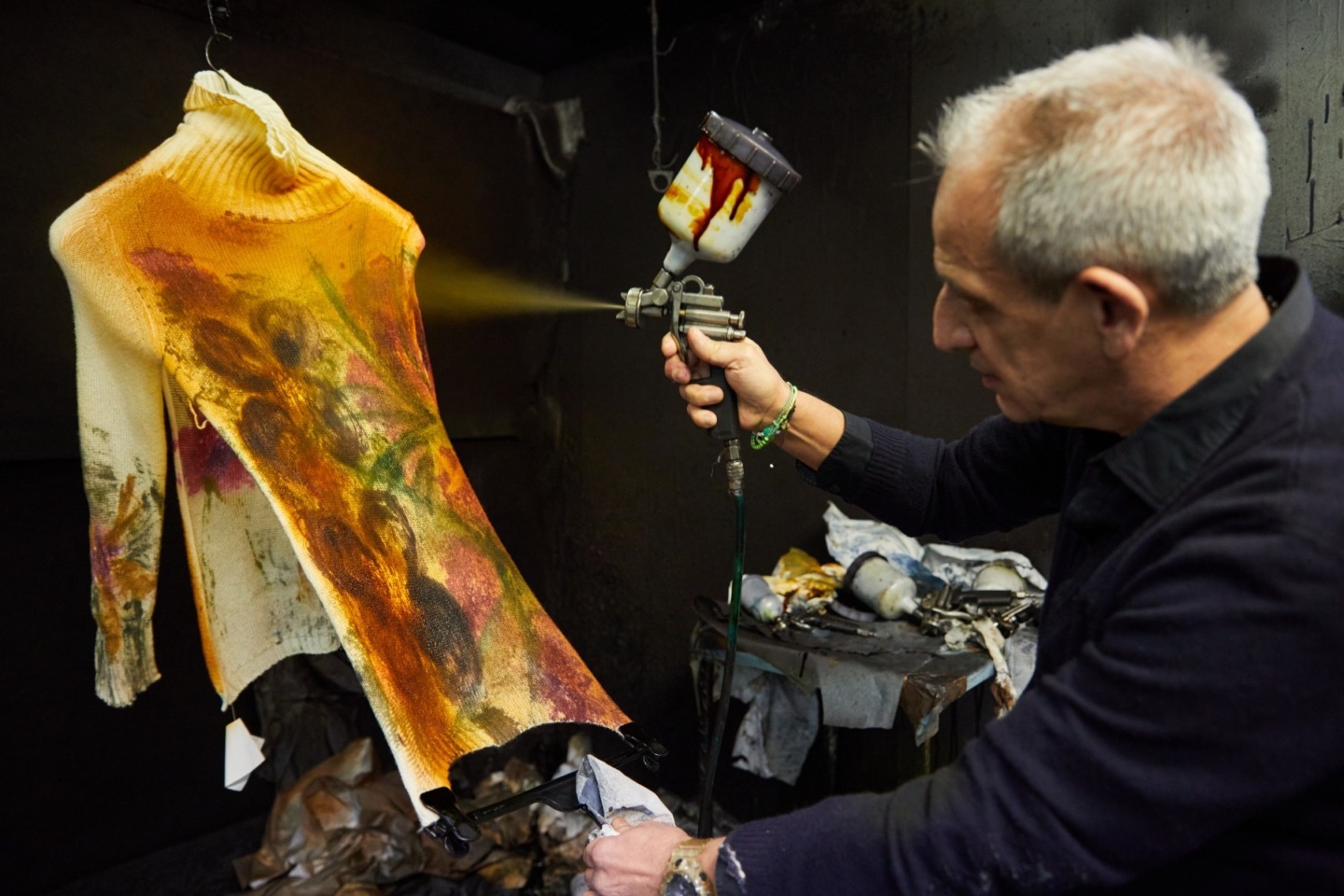 Mirko Ghignone Spray Painting onto a Sweater