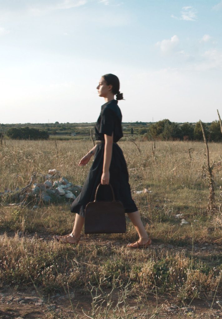 Woman Walking with Corîu Italian Leather Handbag