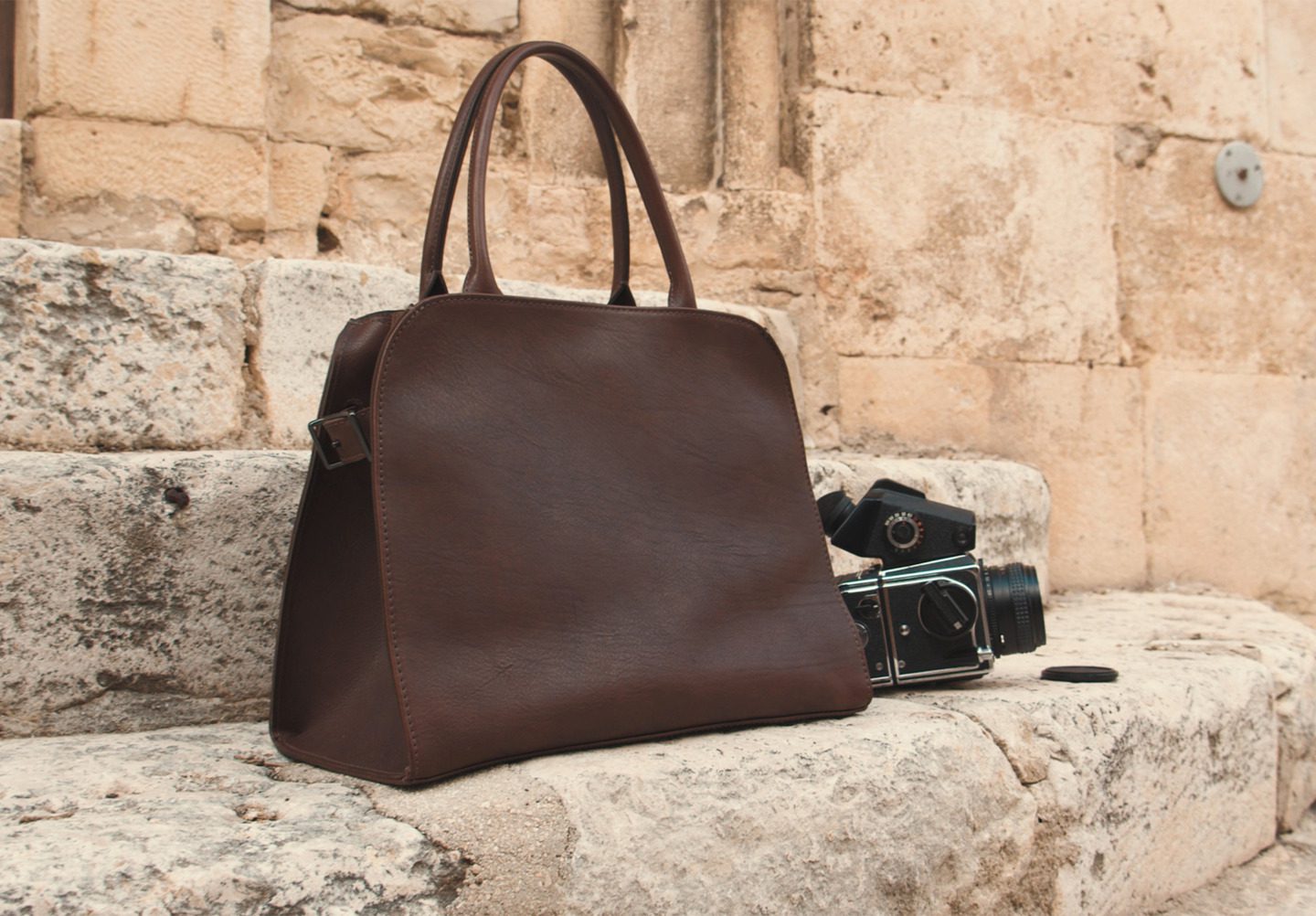 Corîu Italian Leather Handbag posed with Medium Format Film Camera on Steps