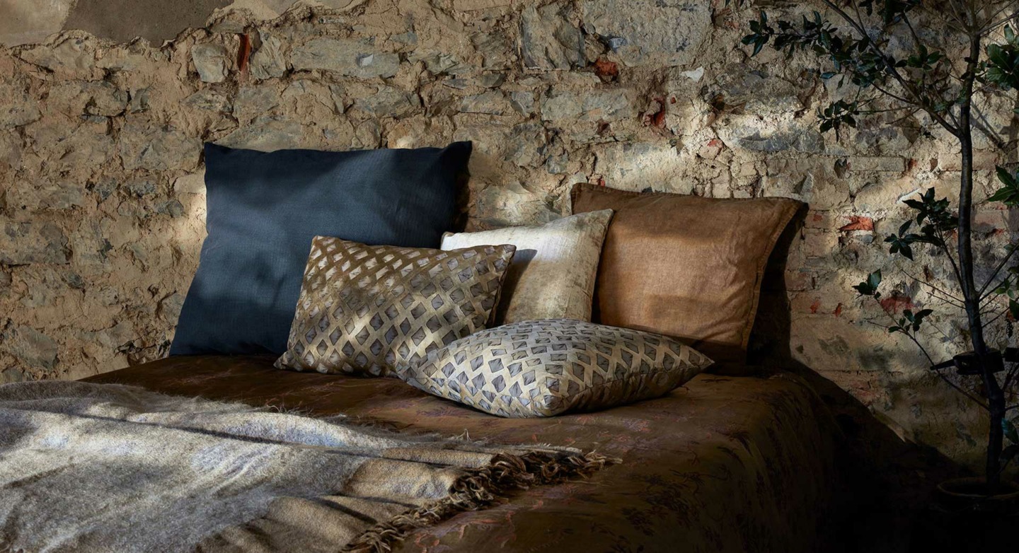 The House of Lyria Pillows and Throw on Bed