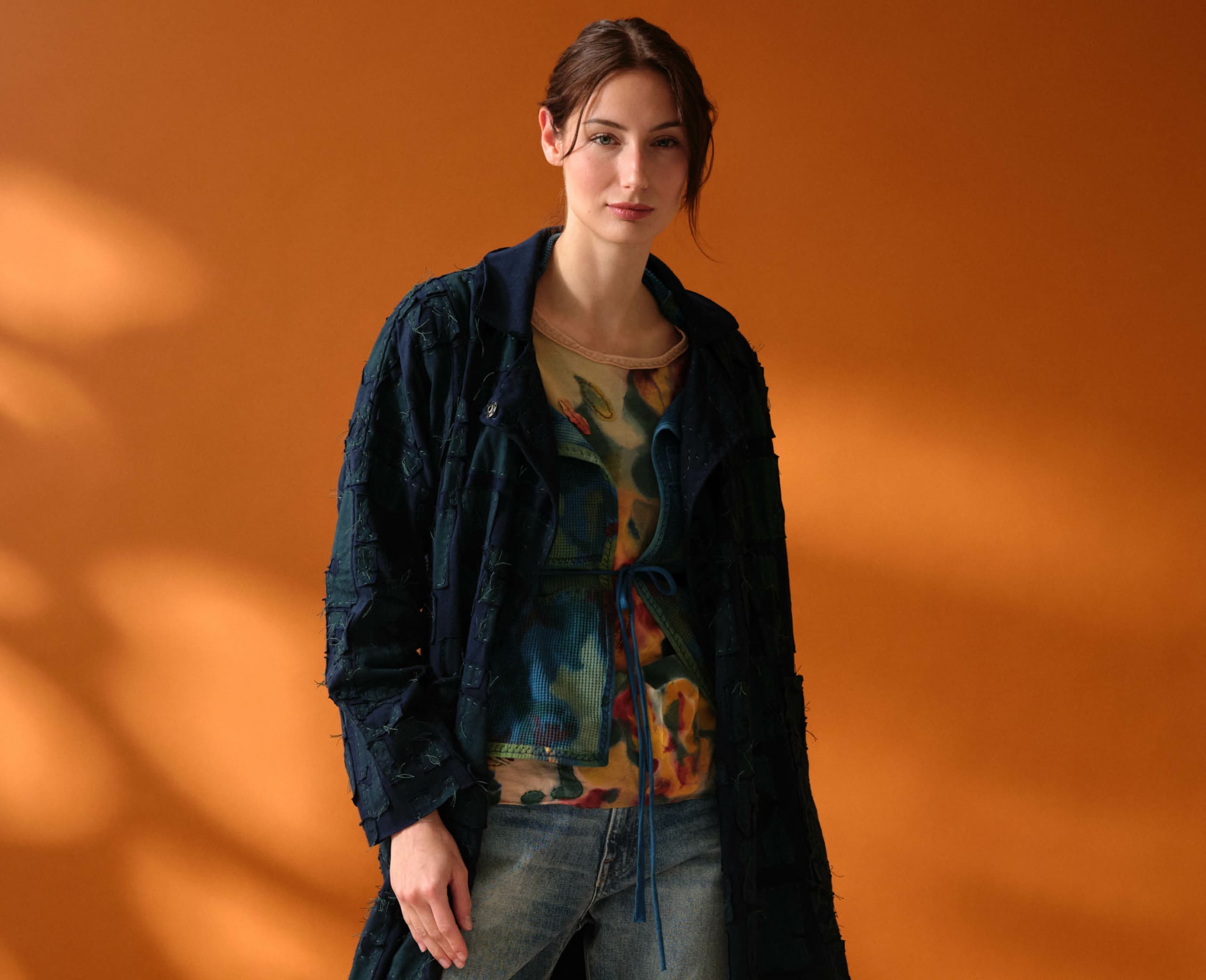 Model wearing Alabama Chanin Organic Cotton "Abstract Suns" Bold Coat in Midnight Teal, Artisan-made organic cotton apparel